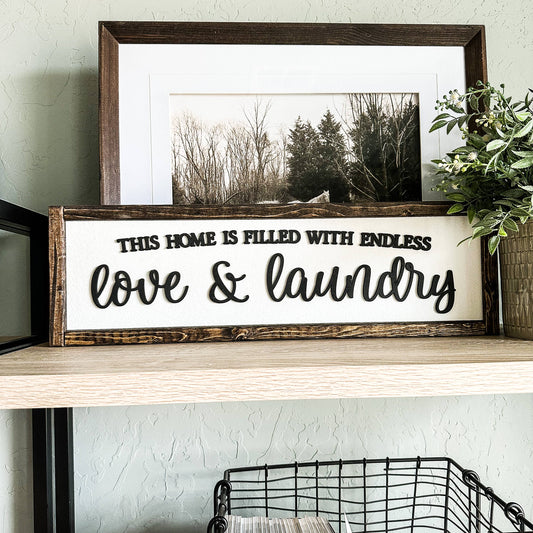 'This Home Is Filled With Love And Laundry' Wooden Sign