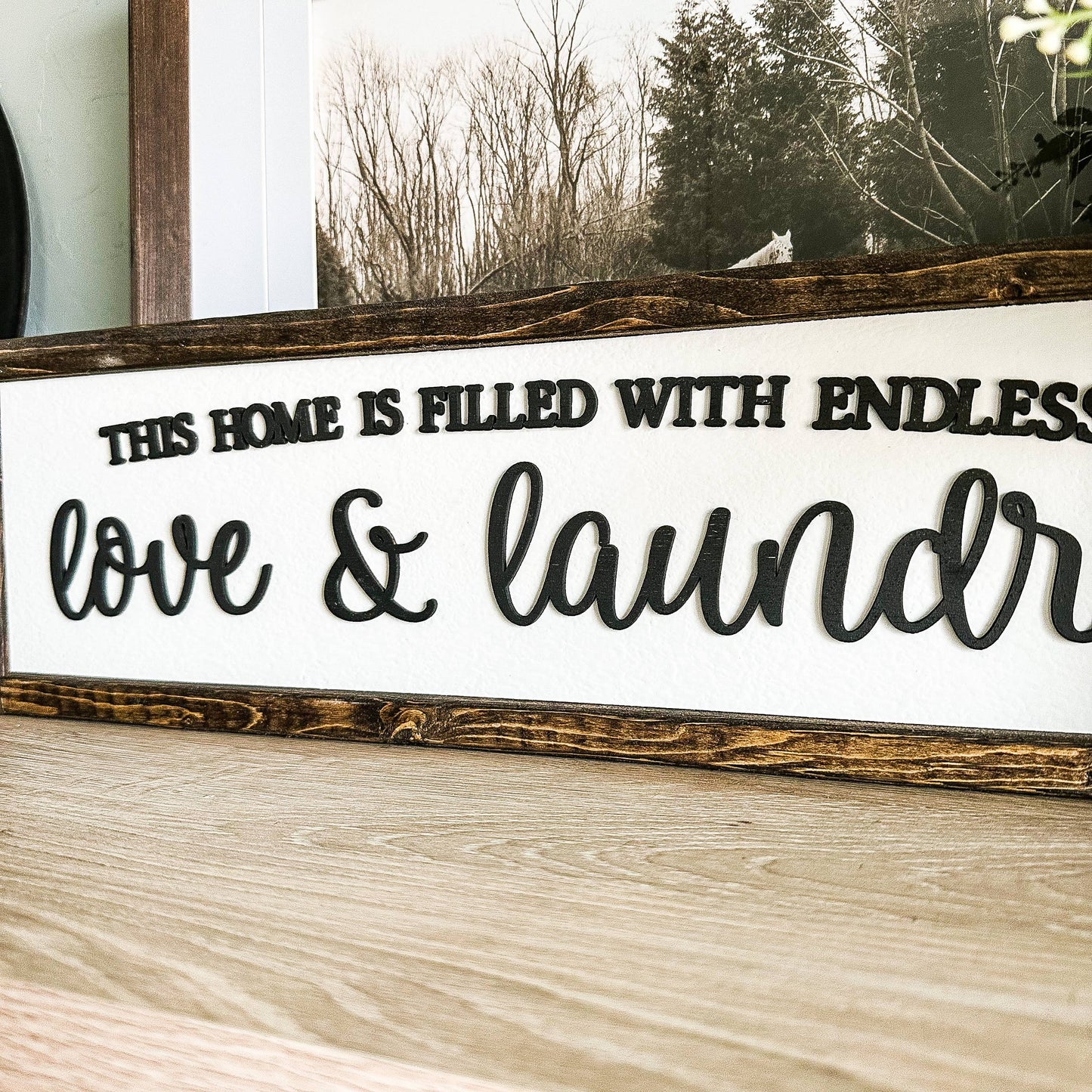 'This Home Is Filled With Love And Laundry' Wooden Sign